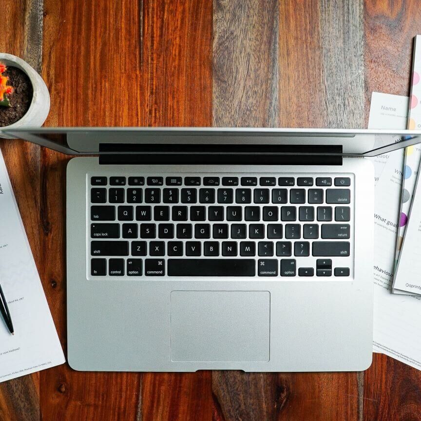laptop and papers on a desk