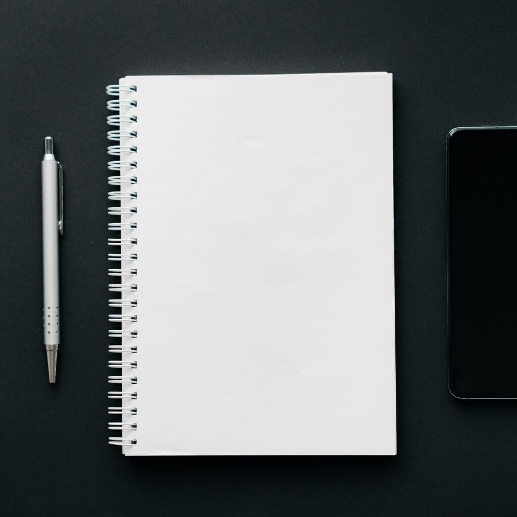 paper and pen aligned neatly on a table