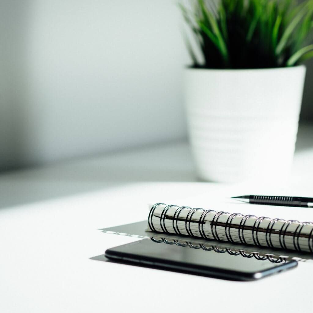 notepad and pen on a desk