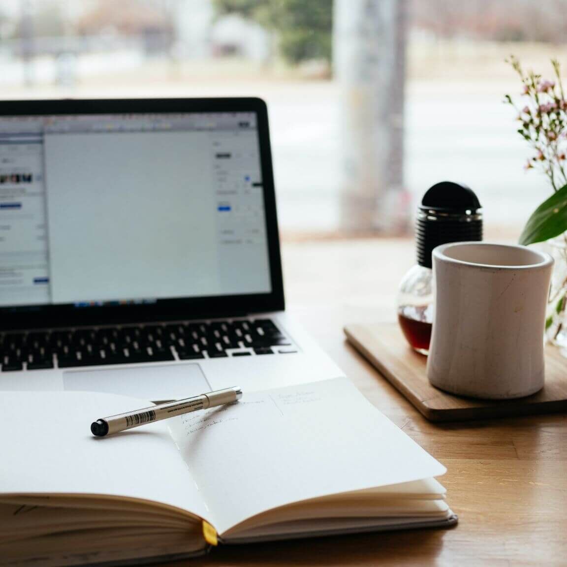 laptop and book at a table